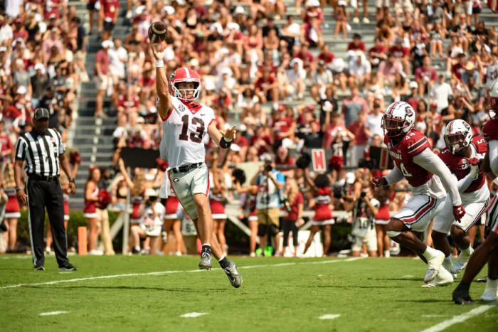 Stetson Bennett scrambles out of the pocket to complete a pass.